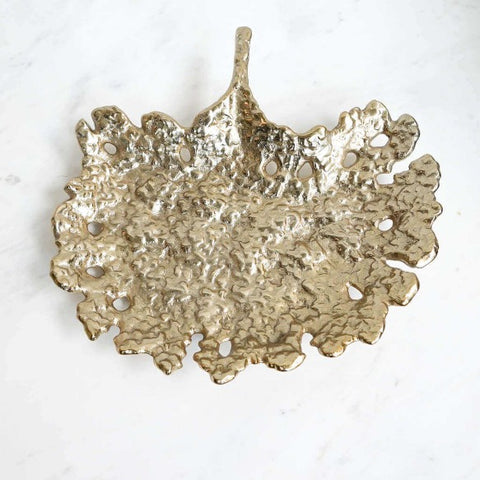 Gold textured sculpture tray crafted in gold metal.