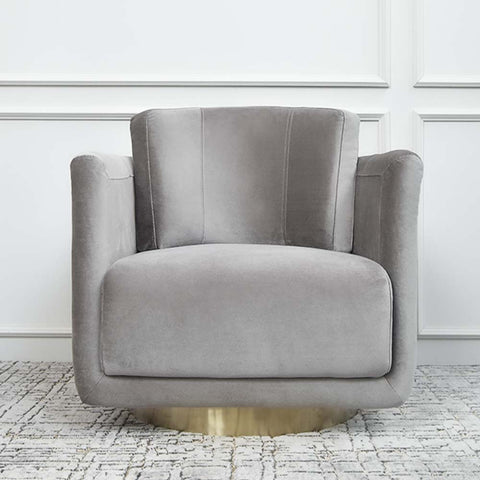 Clyde curved armchair showcases a smooth lush grey velvet upholstery. It sits on a brushed gold stainless steel base which makes it look incredibly luxurious. Its all-round back cushion provides high quality back support.