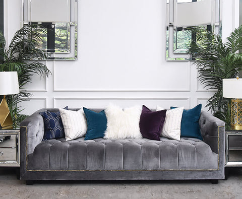 A bold combination of grey and cool toned down feather pillows and Earl of Chesterfield grey velvet sofa.