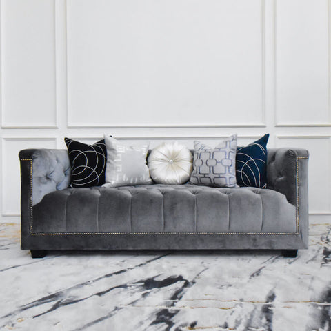 Esquire of Chesterfield grey velvet sofa, 3 seater size, adorned with bold cushions in grey and blue, it is sure to be a statement piece.