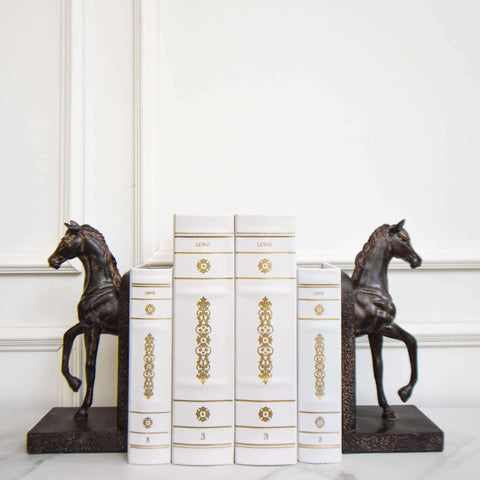 Stallion horses bookend decor sculpture displayed with white leather books for shelf decor.