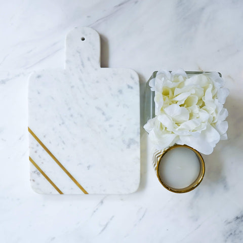 Park Avenue White Marble Tray, Brass Inlay, Paddle Cheese Board and Platter on Dining Table Decor with candle and flower.